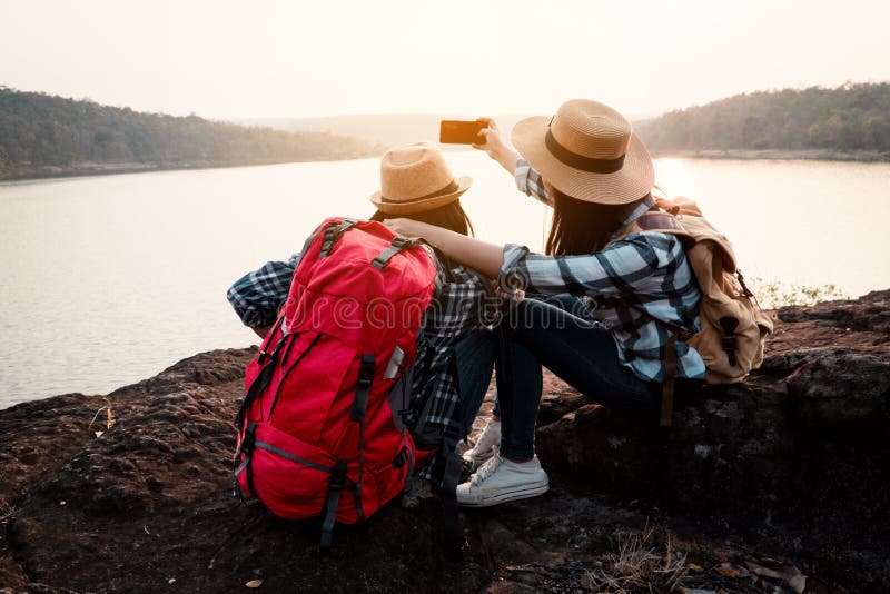 Asian women backpack on the park journey and traveling on holiday stock images Asian women backpack on the park journey and traveling on holiday stock images