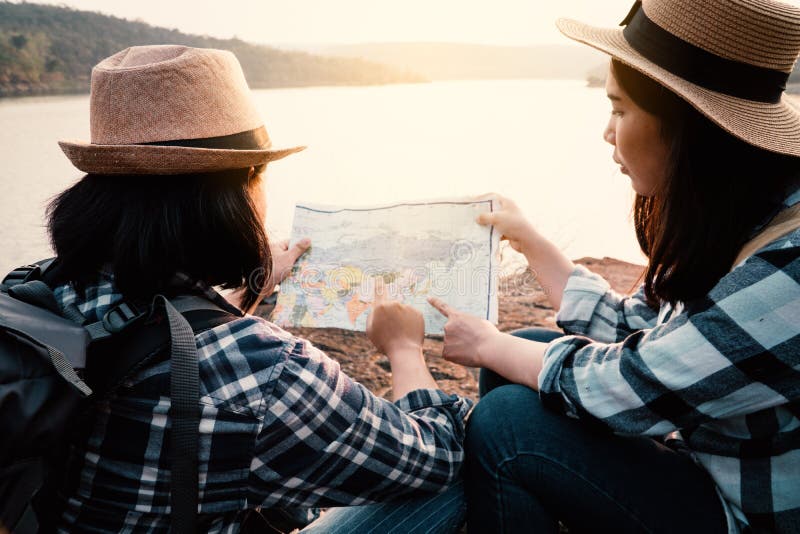 Asian women backpack on the park journey and traveling on holiday stock image Asian women backpack on the park journey and traveling on holiday stock image