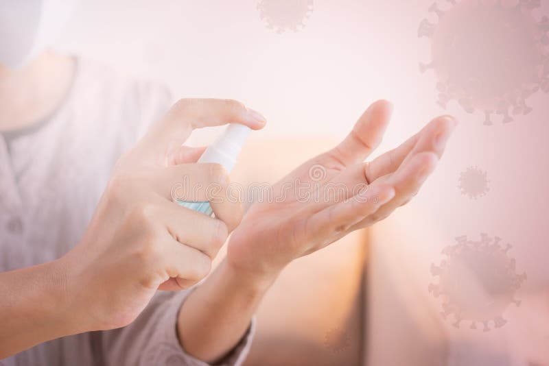 Asian women clean hand with alcohol sanitizer spray prevent the spread of germs and bacteria and avoid virus covid-19 on the. Background cell virus at home royalty free stock image Asian women clean hand with alcohol sanitizer spray prevent the spread of germs and bacteria and avoid virus covid-19 on the. Background cell virus at home royalty free stock image