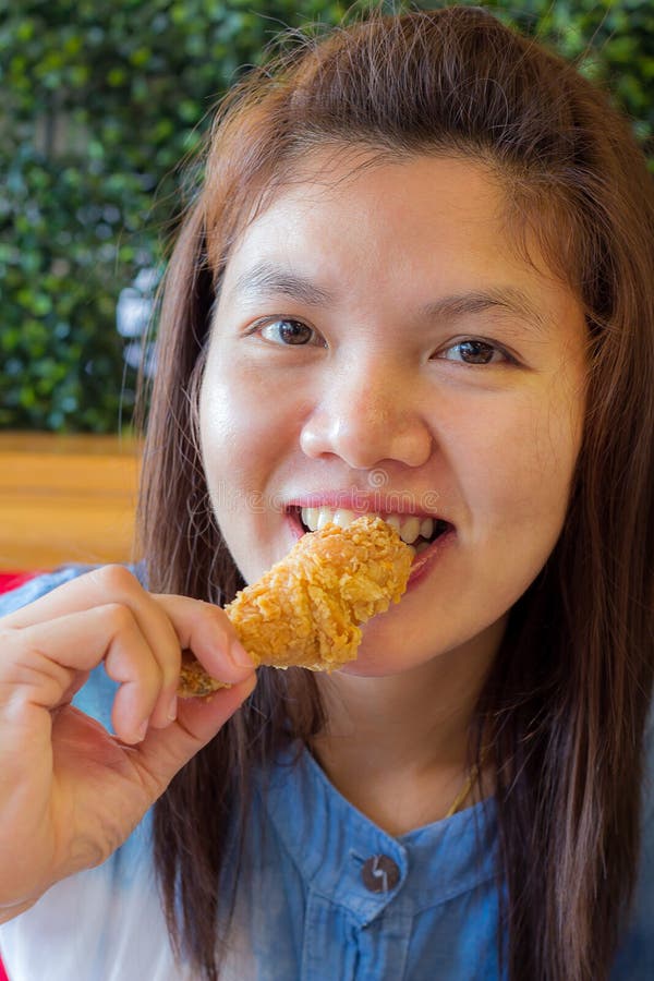 Asian women eating fried chicken