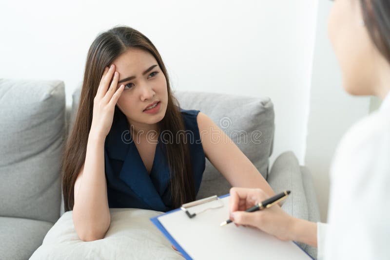Asian women have headache are sick. So she went to see a doctor to check the symptoms. Health and illness concepts stock images Asian women have headache are sick. So she went to see a doctor to check the symptoms. Health and illness concepts stock images