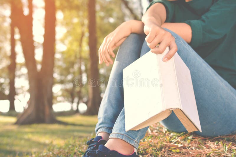 Asian women reading a book in nature stock images Asian women reading a book in nature stock images