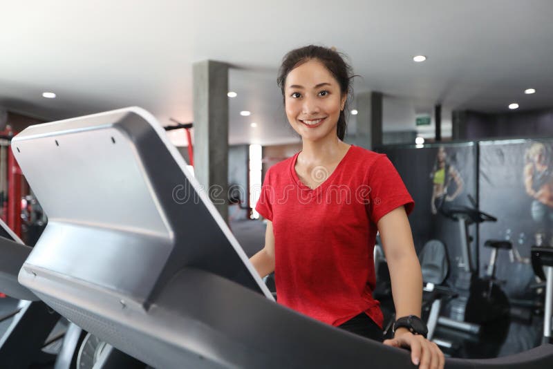 Asian women running sport shoes at the gym while a young caucasian woman is having jogging on the treadmill stock photography Asian women running sport shoes at the gym while a young caucasian woman is having jogging on the treadmill stock photography