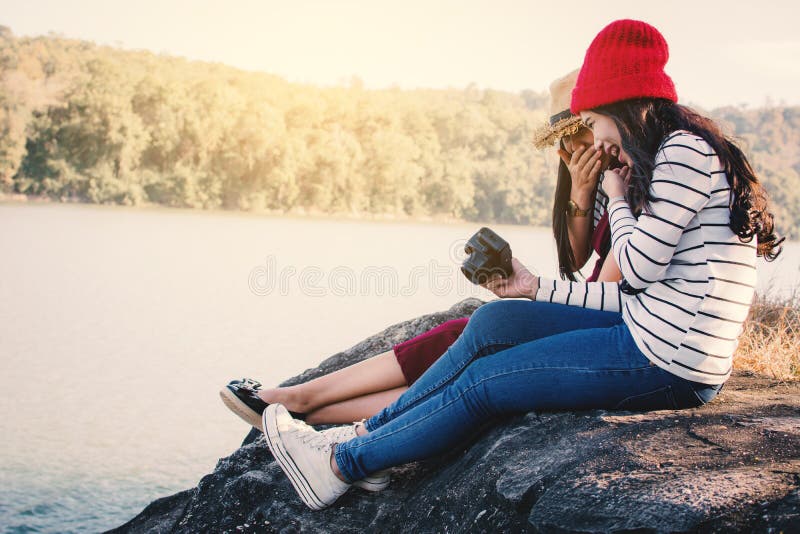Asian women shooting picture in nature stock images Asian women shooting picture in nature stock images