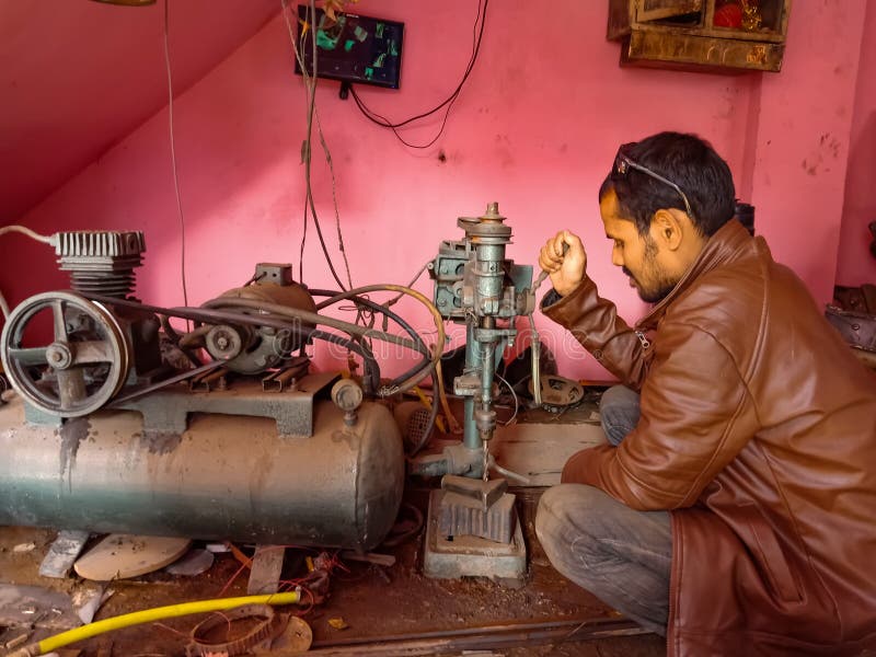 an asian worker operating machine at workshop in india January 2020 royalty free stock photography an asian worker operating machine at workshop in india January 2020 royalty free stock photography