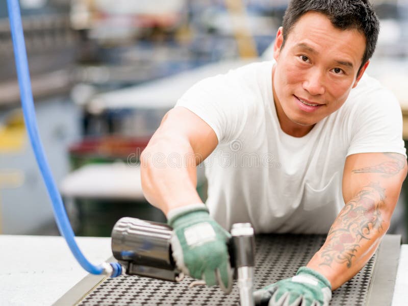 Asian worker in production plant on the factory floor royalty free stock photography Asian worker in production plant on the factory floor royalty free stock photography