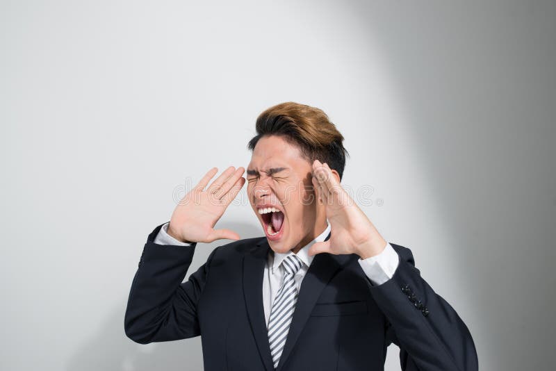 Asian young business man in classic black suit shouting out loud royalty free stock image Asian young business man in classic black suit shouting out loud royalty free stock image