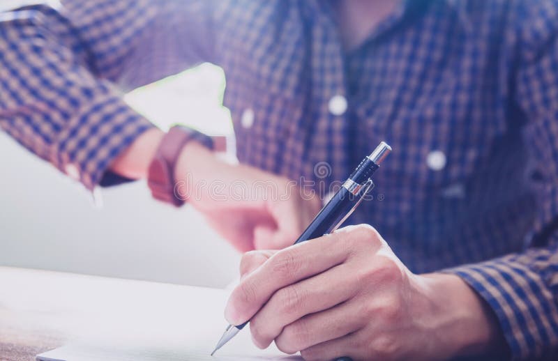Asian young business man of student holding a pen writing letter on paper at home royalty free stock images Asian young business man of student holding a pen writing letter on paper at home royalty free stock images
