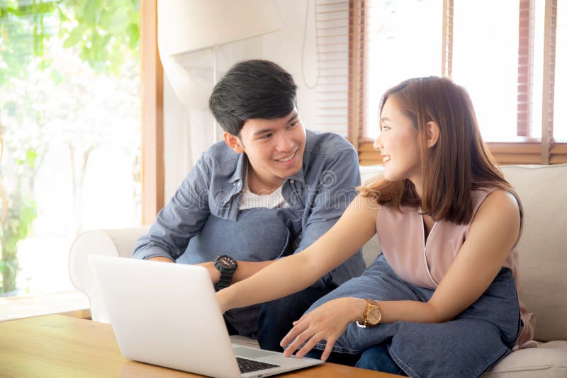 Asian young couple using laptop computer think and searching internet together stock photography Asian young couple using laptop computer think and searching internet together stock photography