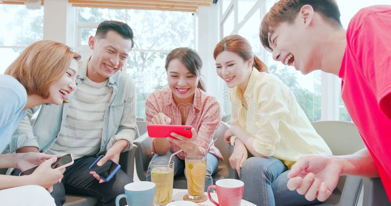 Friends watch video on phone stock photos