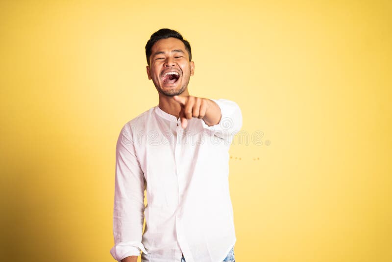 asian young man laughing with finger pointing hand gesture