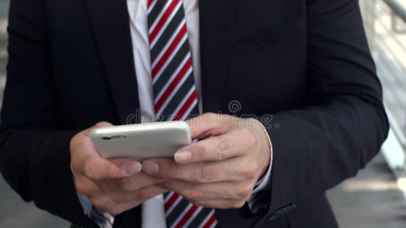 Asian young man using his smart phone outdoors