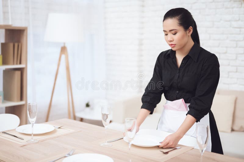 Asiatin wird die Tabelle in einem großen Raum ein lizenzfreies stockbild