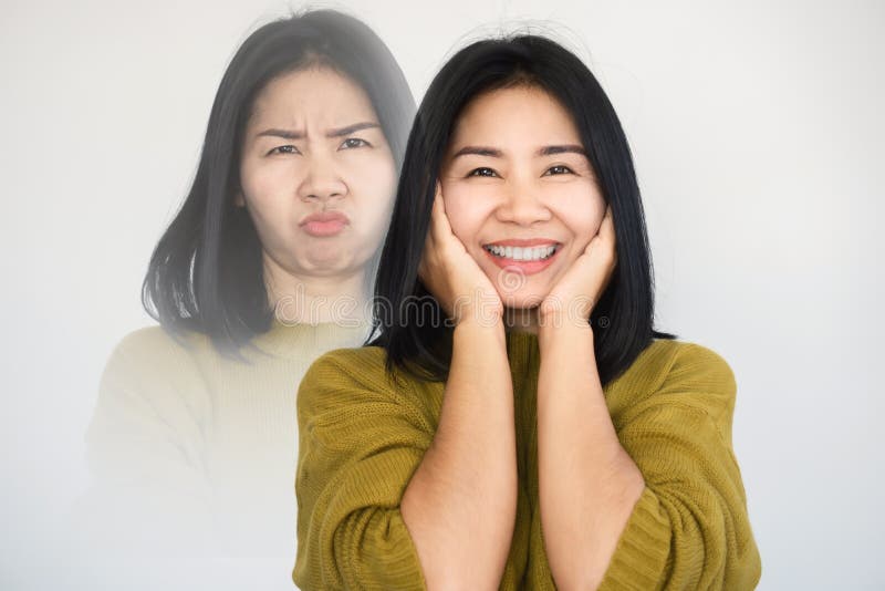 Asiatische Frau, die Persönlichkeitsspaltungsstimmungswechsel oder bipolare Störung mit schwermütigem glücklich Gesicht der versch
