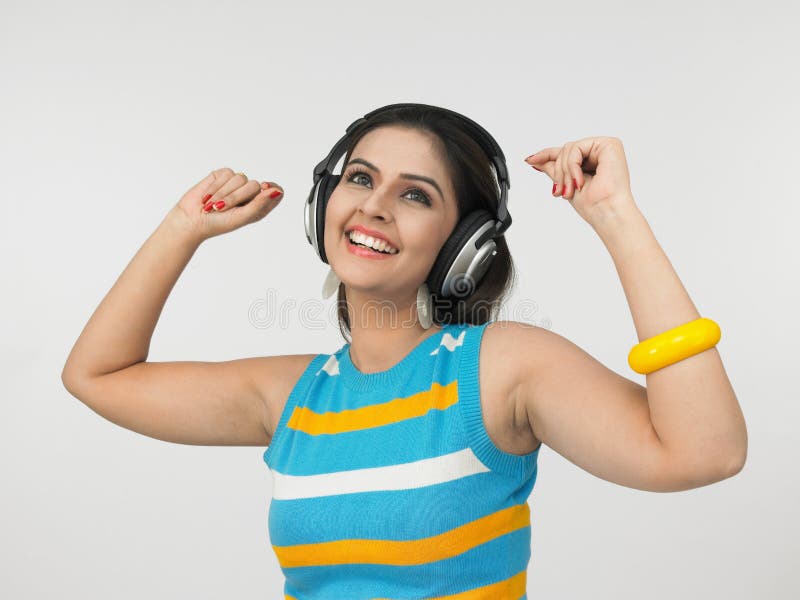 Pretty asian female of indian origin enjoying music. Pretty asian female of indian origin enjoying music