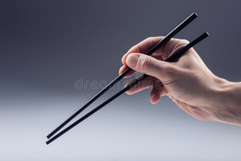 Asiatisk tradition Asiat som äter med två handtagpinnar