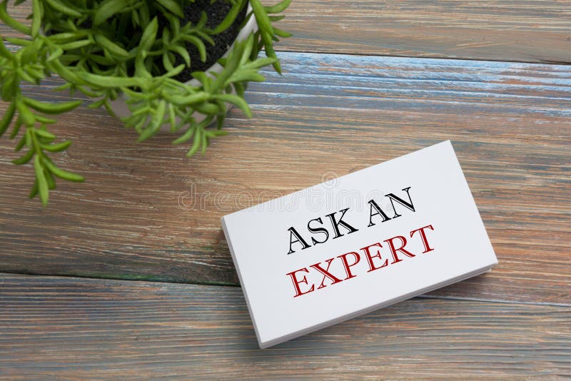 Ask an Expert. Business Card with Message. Office Supplies on Desk