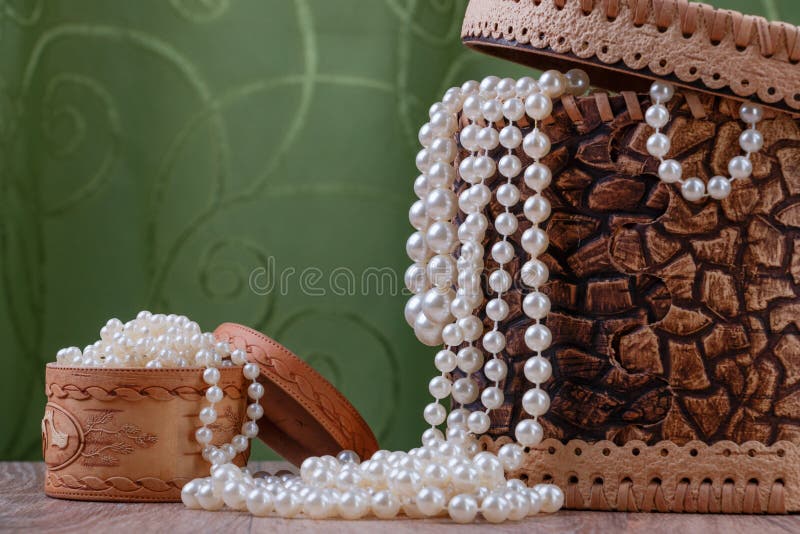 Birch bark boxes with pearl beads on green fabric background. Birch bark boxes with pearl beads on green fabric background