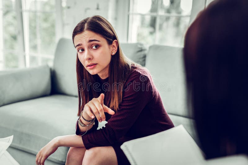 Dark-eyed woman asking some questions to her psychologist stock photo Dark-eyed woman asking some questions to her psychologist stock photo