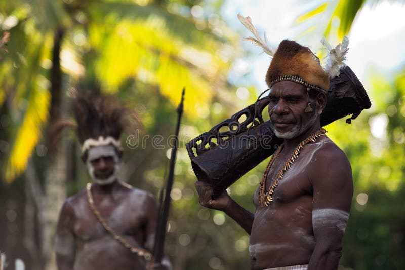 INDONESIA, IRIAN JAYA, ASMAT PROVINCE, JOW VILLAGE - JUNY 28: Portrait of Asmat tribesman with drum in Jow Village of the region Asmat. New Guinea Island, Indonesia. June 28 2012. INDONESIA, IRIAN JAYA, ASMAT PROVINCE, JOW VILLAGE - JUNY 28: Portrait of Asmat tribesman with drum in Jow Village of the region Asmat. New Guinea Island, Indonesia. June 28 2012