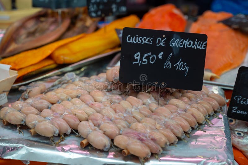 Assortment of meat on weekly food market in France, English translation: chicken eggs in jelly price of 1 piece. Assortment of meat on weekly food market in France, English translation: chicken eggs in jelly price of 1 piece