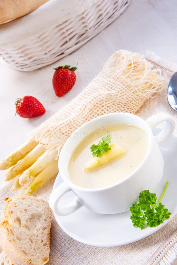 Asparagus cream soup with capers and fresh baguette