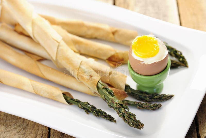 Asparagus Wrapped in Bacon Slices with Poched Egg and Parmesan Stock