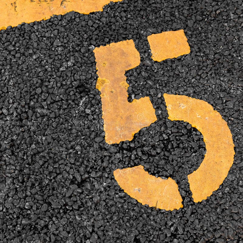 Asphalt parking lot with yellow lot line and yellow lot number 5, five, fifth royalty free stock photos