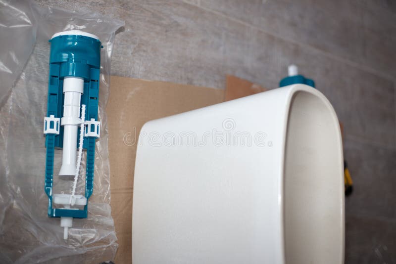 Assembling the Toilet. Water Pump Near the Ceramic Tank Stock Image