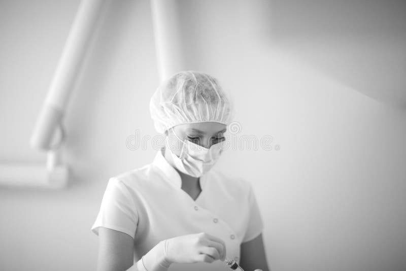 Assistant Dentist Chooses a Program in an Autoclave Stock Photo Image