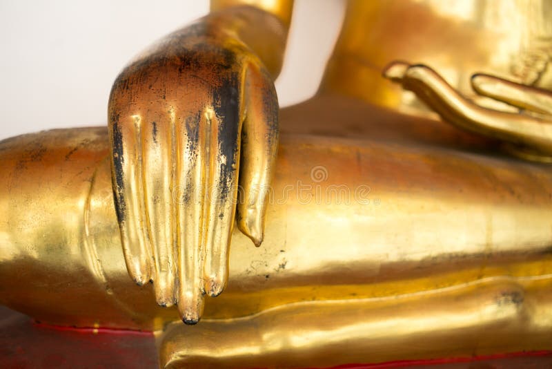 Assistenten av Buddhastatyn för gammal guld sitter det lade benen på ryggen korset arkivfoton Assistenten av Buddhastatyn för gammal guld sitter det lade benen på ryggen korset arkivfoton