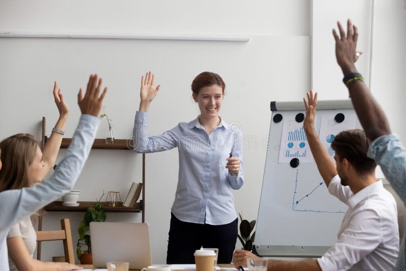 Businesspeople voting raise their hands think the same way, unanimously. Diverse multi-ethnic businesswomen businessmen gathered together in boardroom for training and business knowledge improvement. Businesspeople voting raise their hands think the same way, unanimously. Diverse multi-ethnic businesswomen businessmen gathered together in boardroom for training and business knowledge improvement