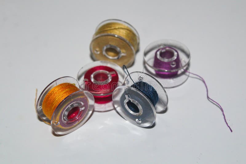 Assorted Colorful Thread Bobbins Placed on a White Surface royalty free stock images