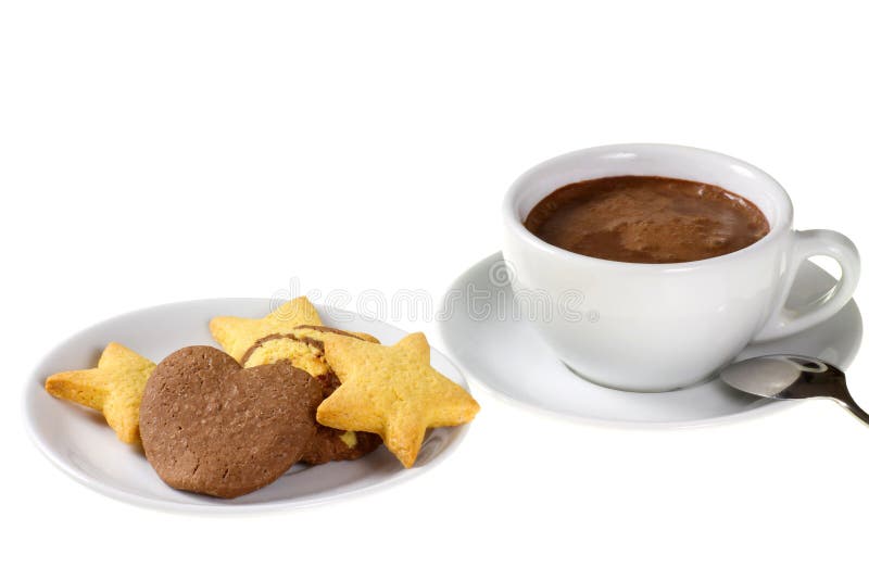 Assorted cookies on white dessert plate and cup of hot chocolate