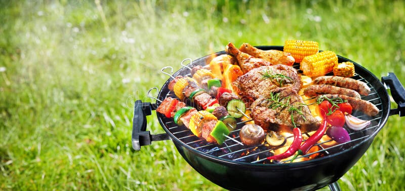 Assorted delicious grilled meat with vegetables on barbecue grill