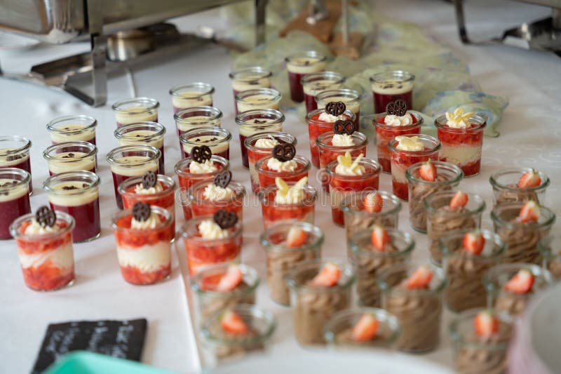 Assorted dessert cups on a buffet table. stock photo