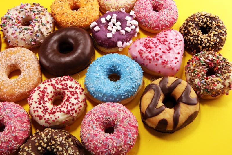 Assorted Donuts with Chocolate Frosted, Pink Glazed and Sprinkles Donuts Stock Photo Image of