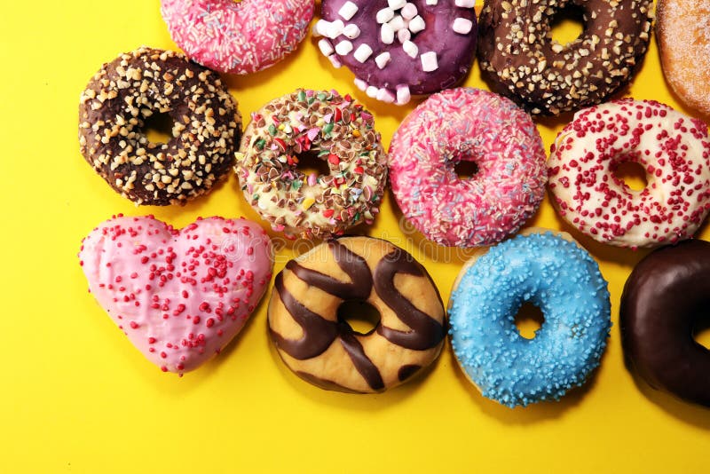 Assorted Donuts with Chocolate Frosted, Pink Glazed and Sprinkles Donuts Stock Photo Image of