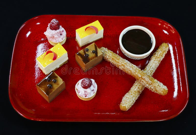 Assorted french pastries in a red color plate