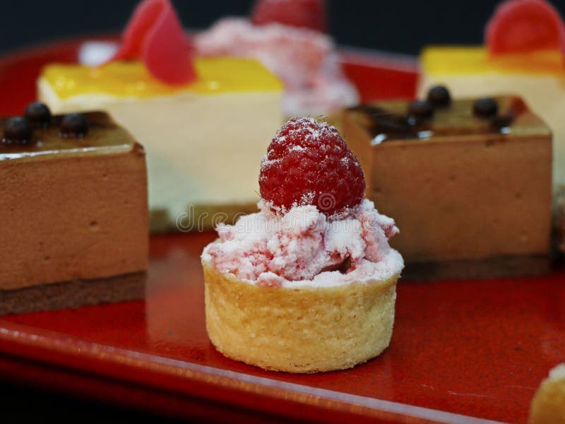 Assorted french pastries in a red color plate