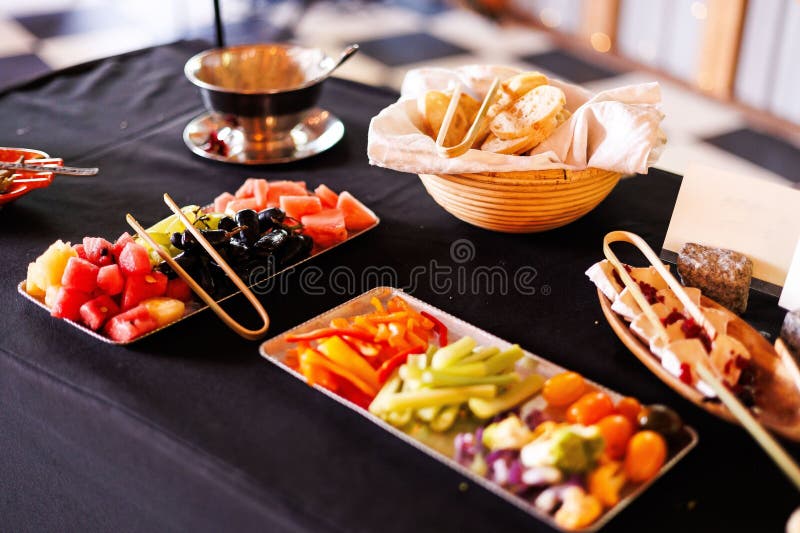 Assorted fruits and vegetables on buffet table. stock image
