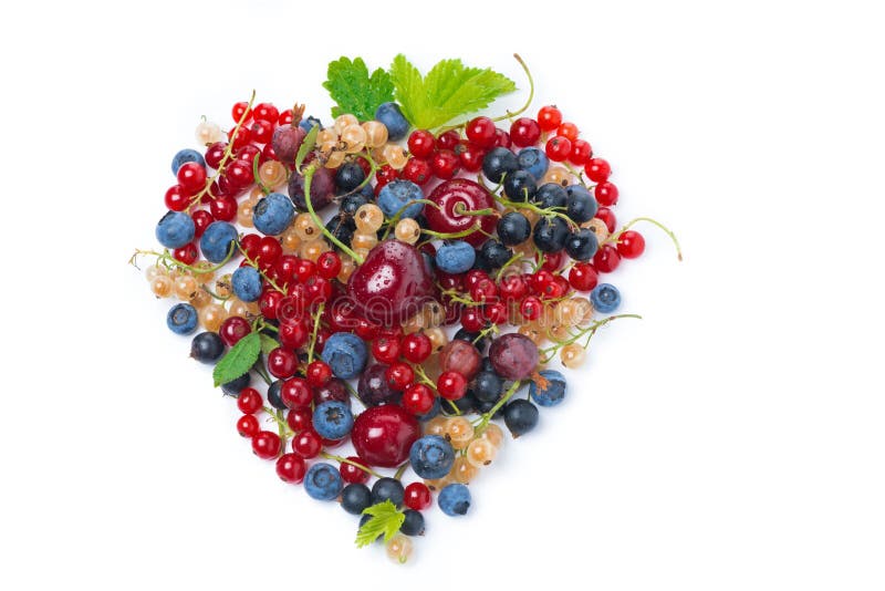 assorted garden berries in a heart-shaped, top view, isolated