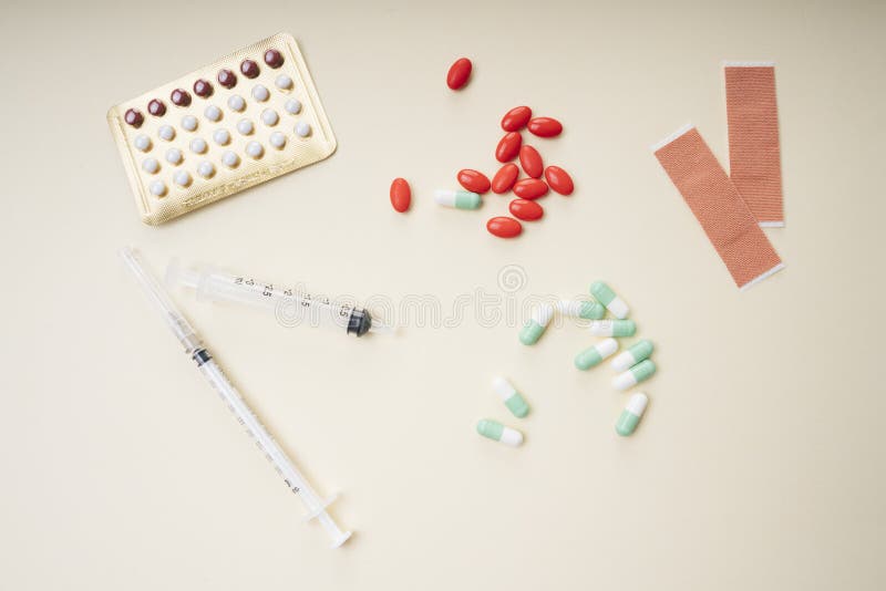 Assorted medical drugs and syringe on white background care tube