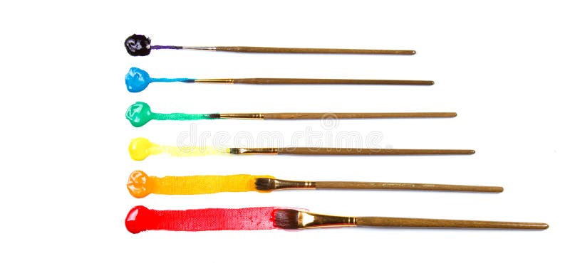 Assorted paint brushes with paint stock images