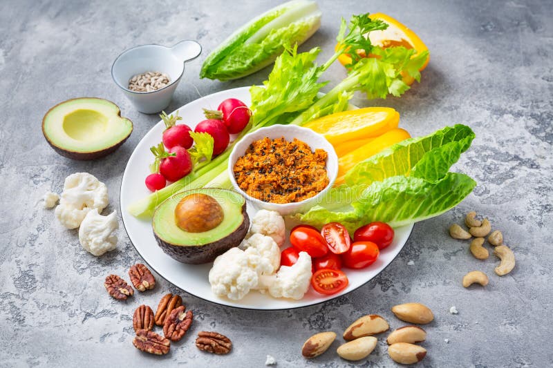 Assorted raw vegetable snacks with carrot hummus and nuts. Paleo cauliflower stock images, royalty-free photos and pictures