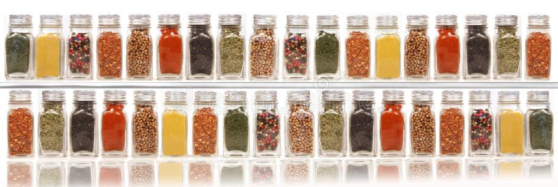 Assorted spices on two layer shelves against white