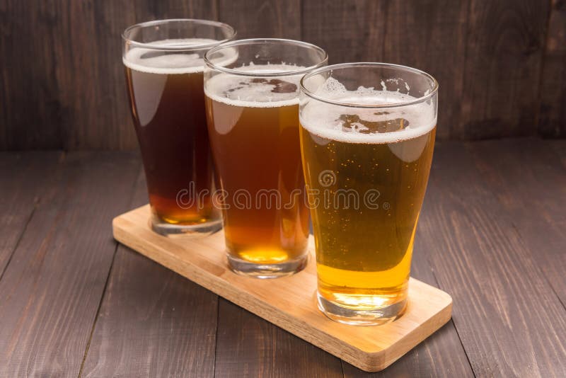 Assortment of beer glasses on a wooden table. Assortment of beer glasses on a wooden table.