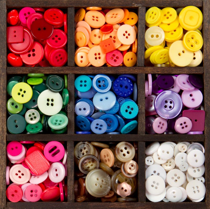 An assortment of buttons in a rainbow of colors, in a printers box. An assortment of buttons in a rainbow of colors, in a printers box