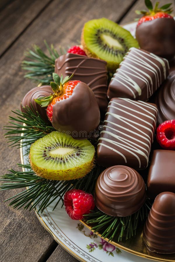An assortment of chocolates and fruits is creatively arranged on a decorative plate royalty free illustration