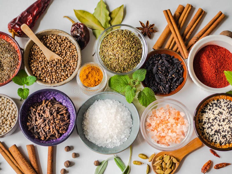 An Assortment of Different Dry Spices in Small Bowls on a White